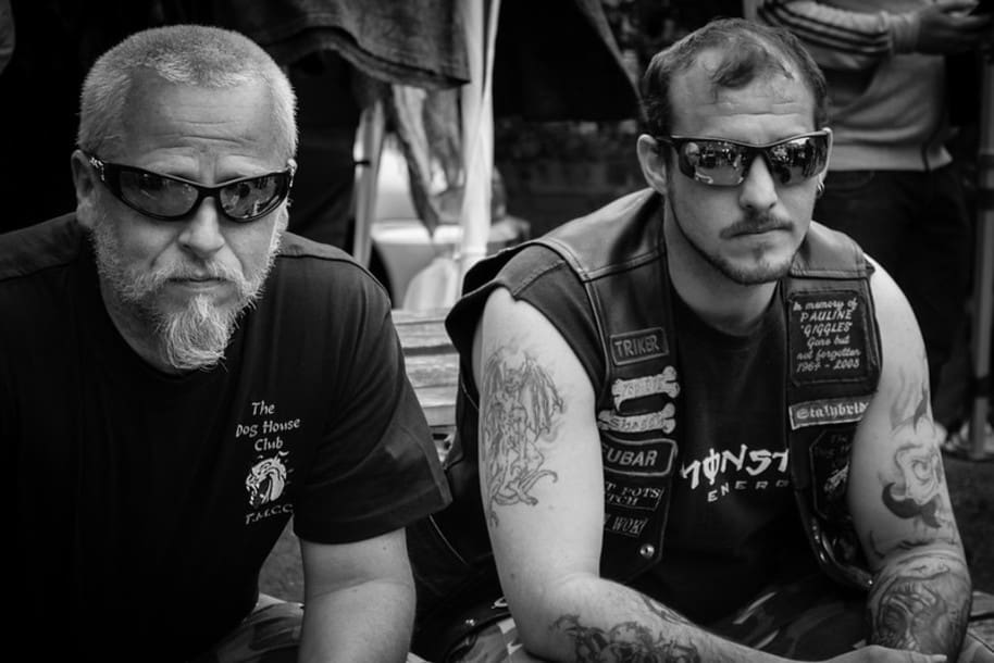 two bikers sitting in motorcycle glasses